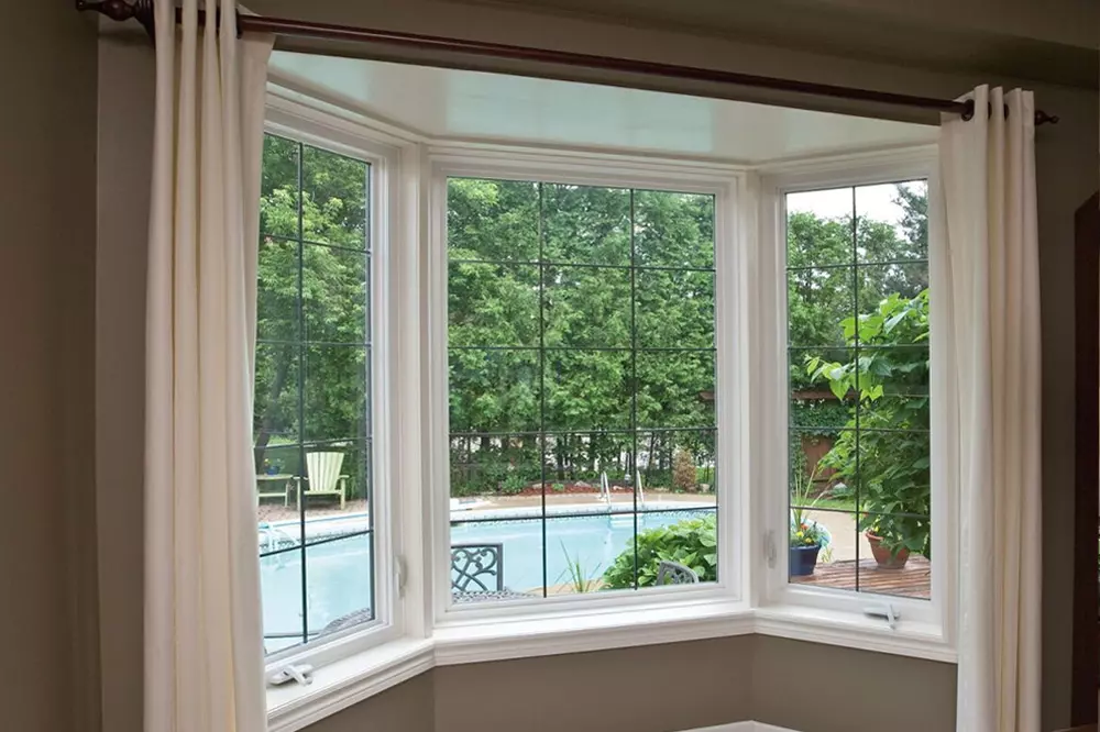 Photo of bay-bow window looking out at backyard with pool