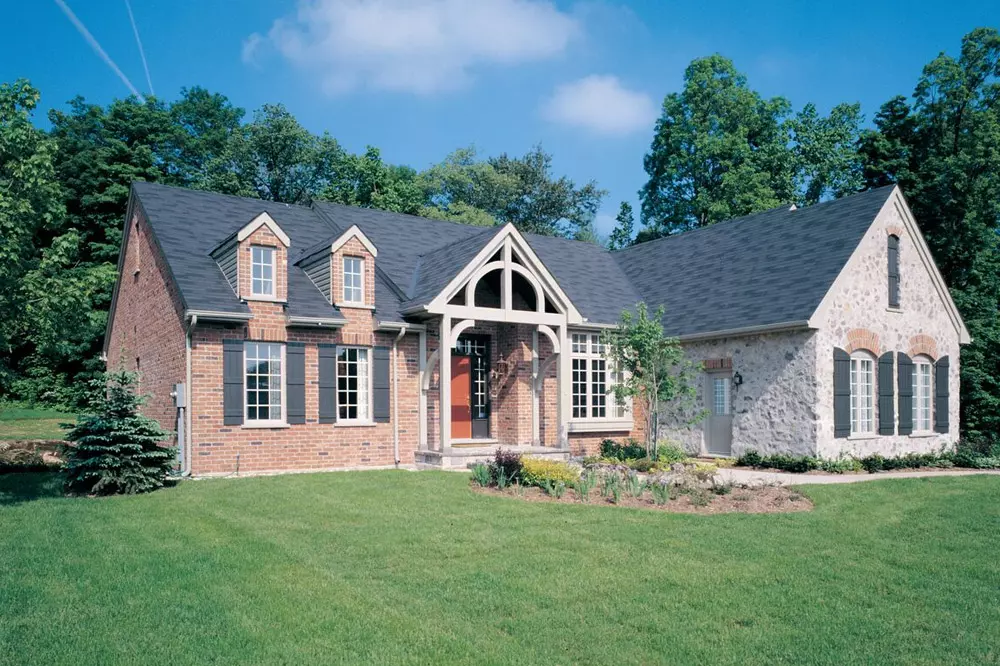 Exterior view of casement windows on light brick and stone home