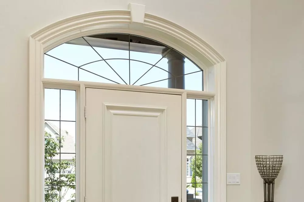 White decorative window installed above main entrance white doors