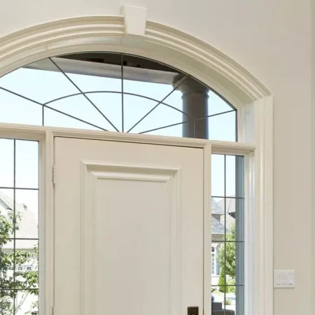 White decorative window installed above main entrance white doors