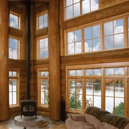 Interior view of a log home with picture and casement windows