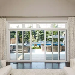 white sliding patio doors leading to back deck with pool and hot tub