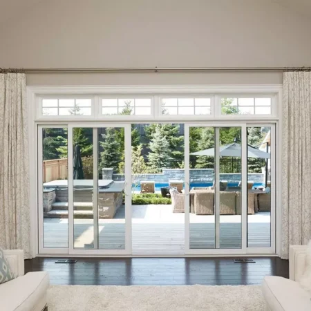 white sliding patio doors leading to back deck with pool and hot tub