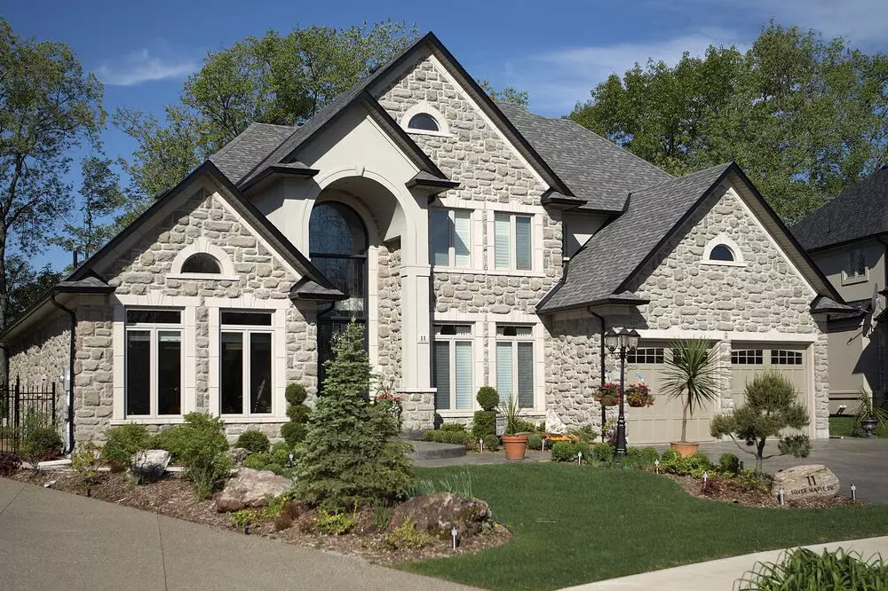 Stone home with decorative windows - brick and stone house