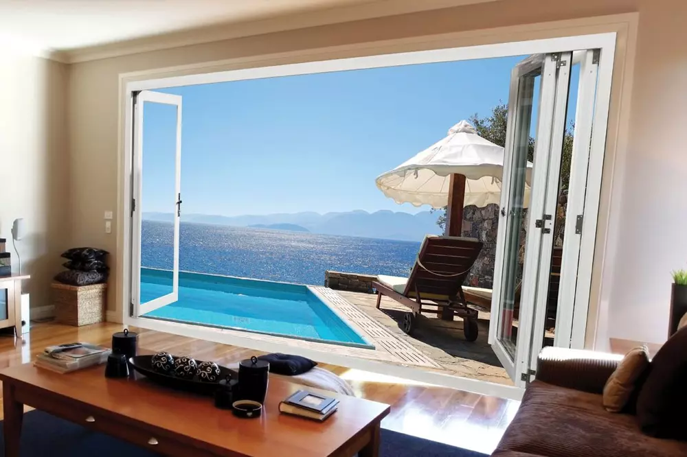 Open Canadian-made panoramic interior/exterior folding doors leading to pool