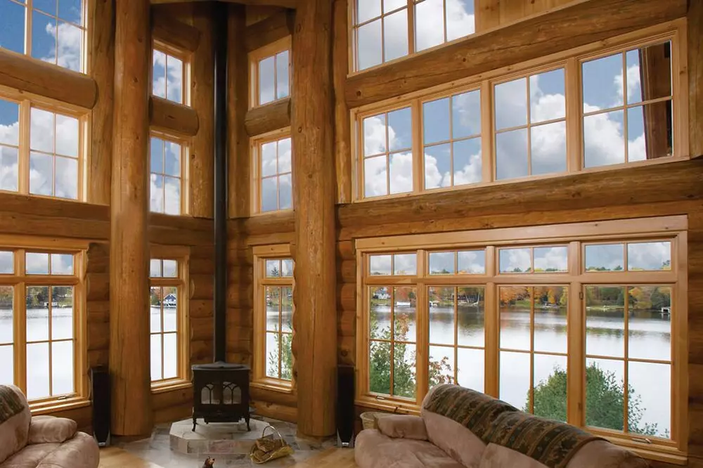 Interior view of a log home with picture and casement windows