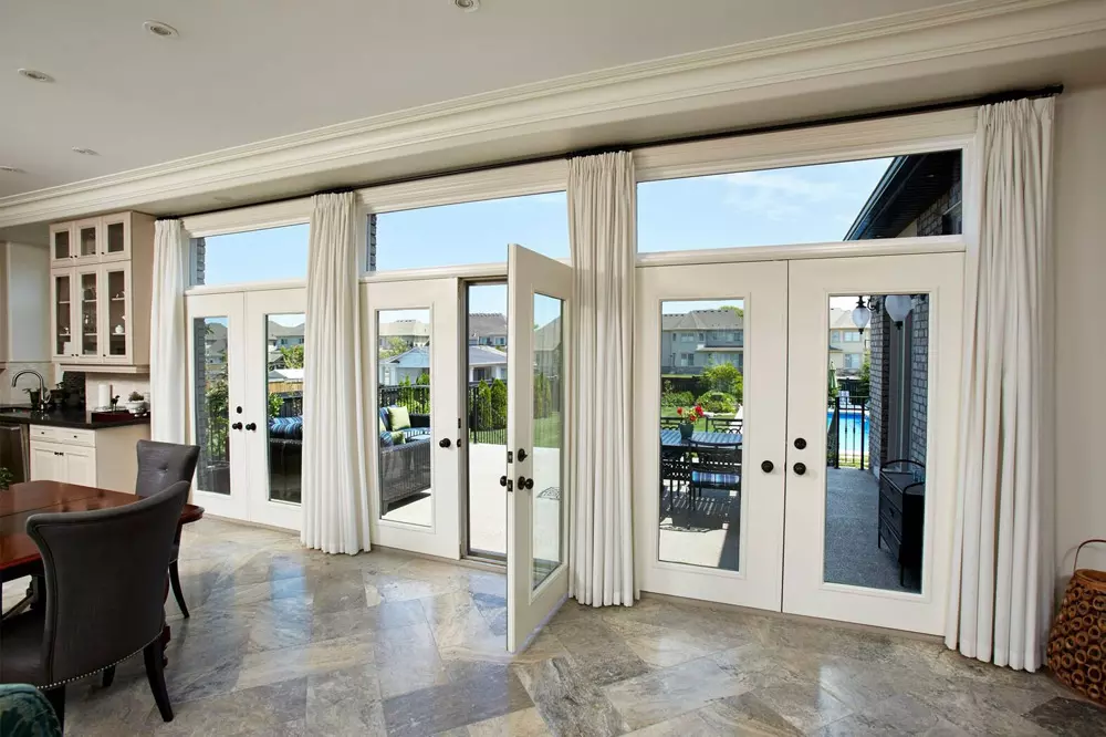 Beautiful image of white terrace doors leading to back deck - open view