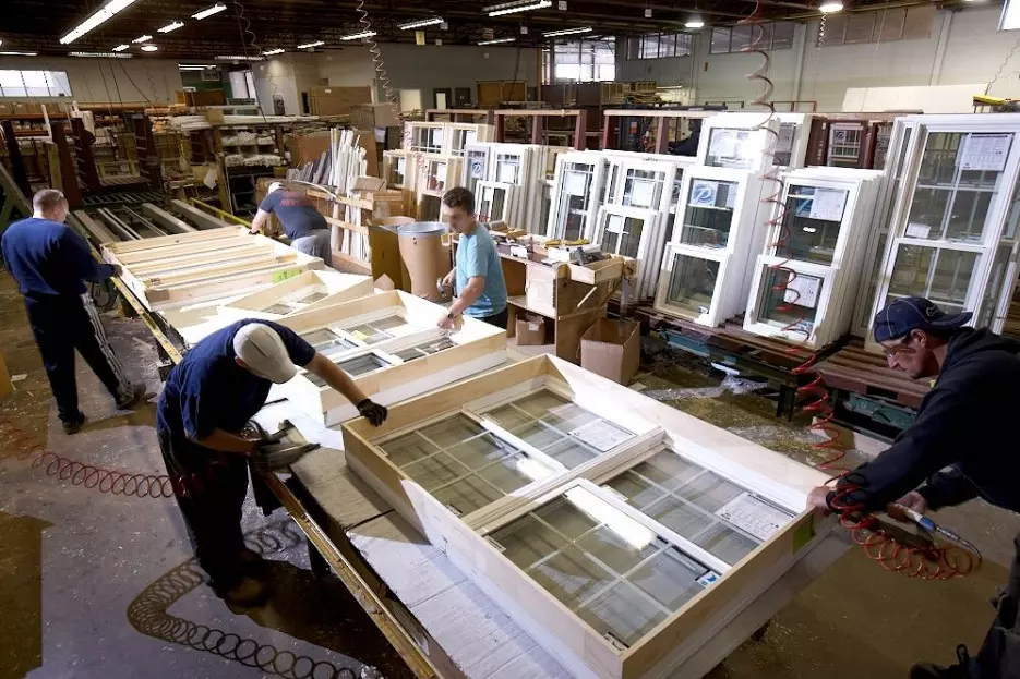 workers during window frame manufacturing process